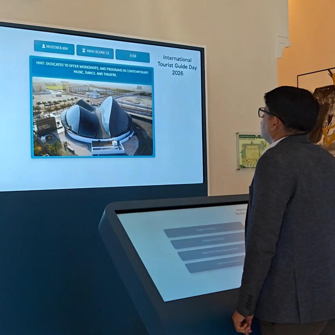 Multi-screen interactive UAE landmark guessing game display with custom branded interface for immersive event activation and digital tourism engagement.